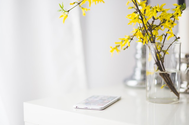 Flowers and cell phone on table